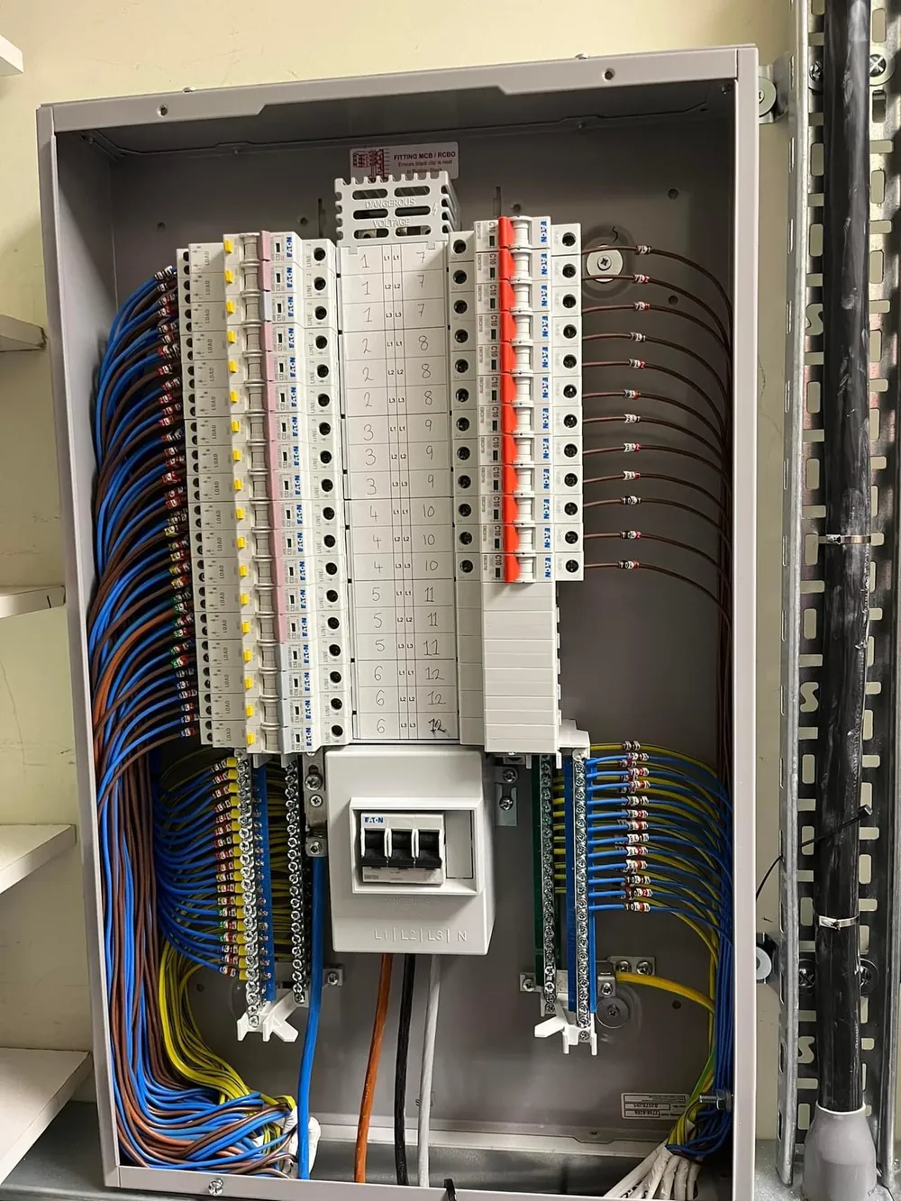 Three-phase commercial distribution board fully labelled and loomed by DTF Electrical during a fixed wire testing programme in Merseyside