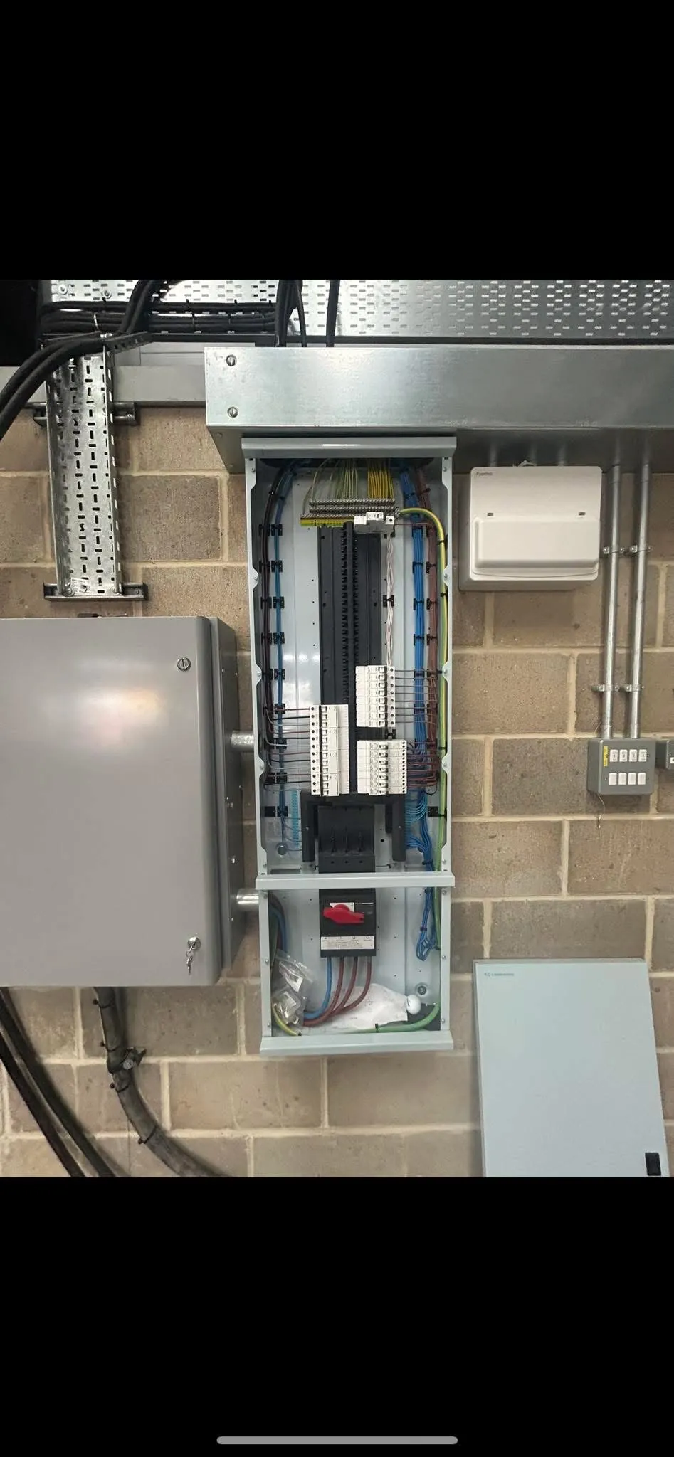 Track lighting and cable containment installed at height in a commercial unit by DTF Electrical